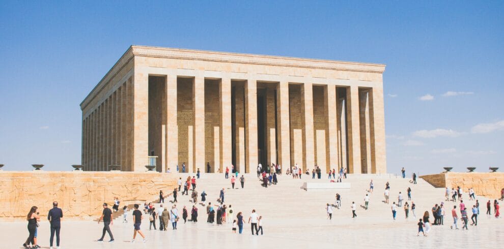 Visitors at Anıtkabir in Ankara, Turkey, under clear blue skies, highlighting architectural grandeur.
