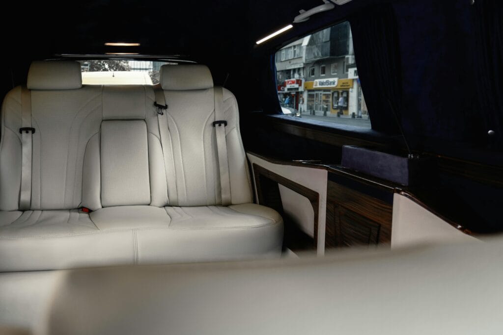 pexels photo 17455626 17455626 Elegant white leather seats in a Mercedes-Benz V-Class with urban view.