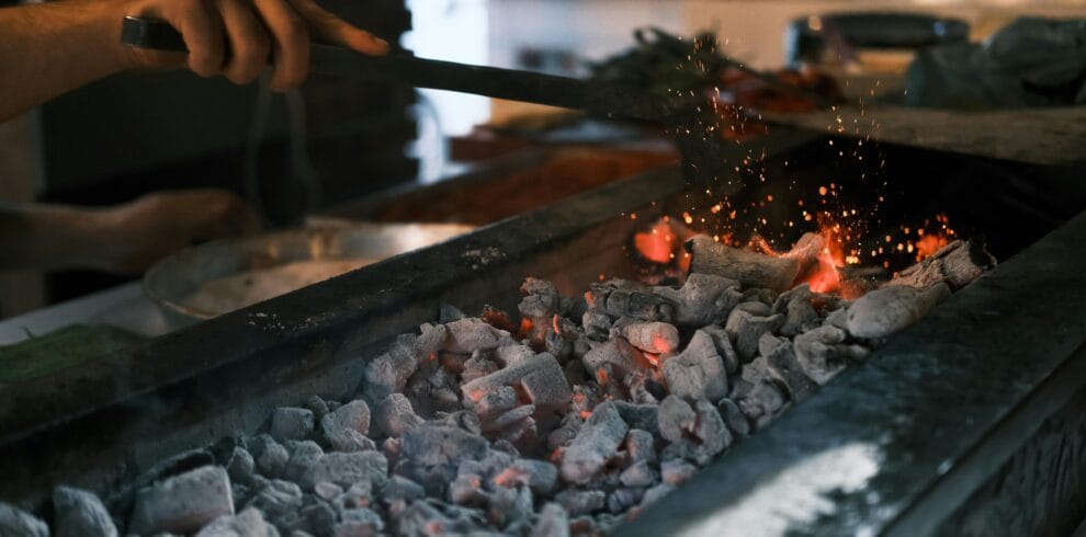 Close-up of glowing coals on a grill being prepared for a barbecue in Diyarbakır, Turkey.