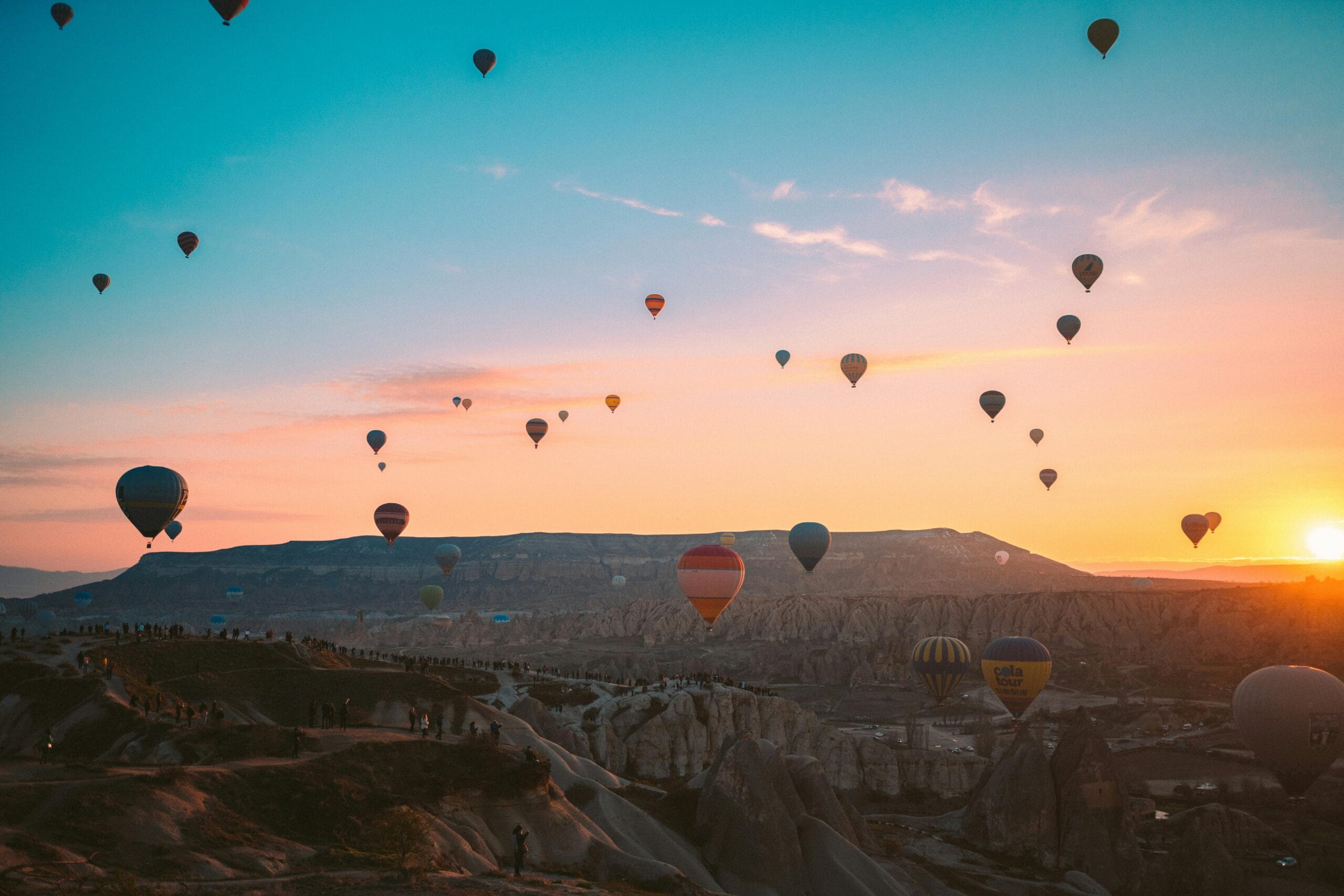 Colorful hot air balloons soaring over Cappadocia at sunrise, Turkey.
